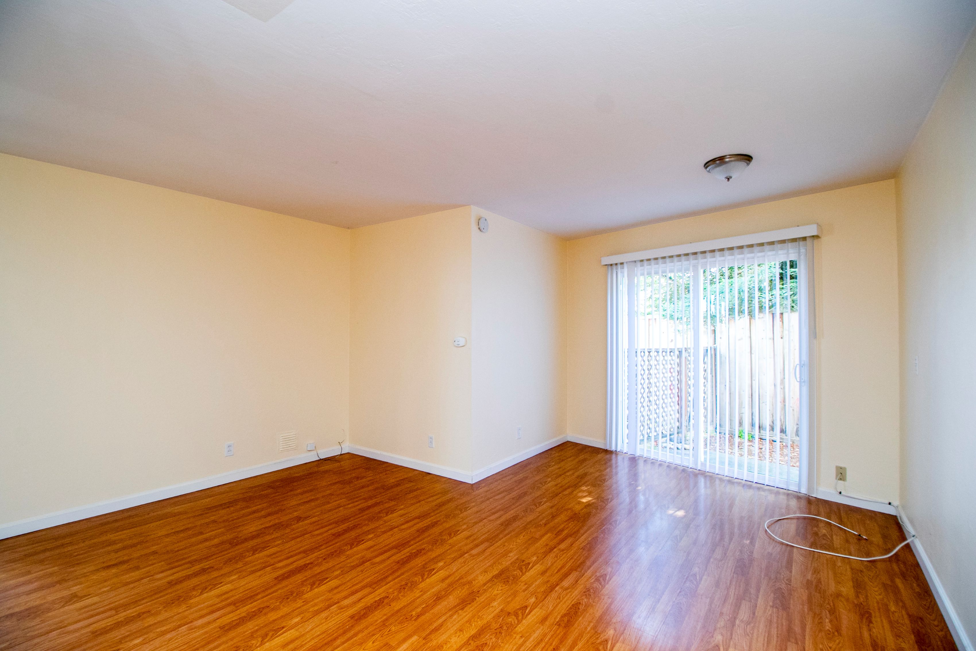 Empty room with wooden floor and white walls.